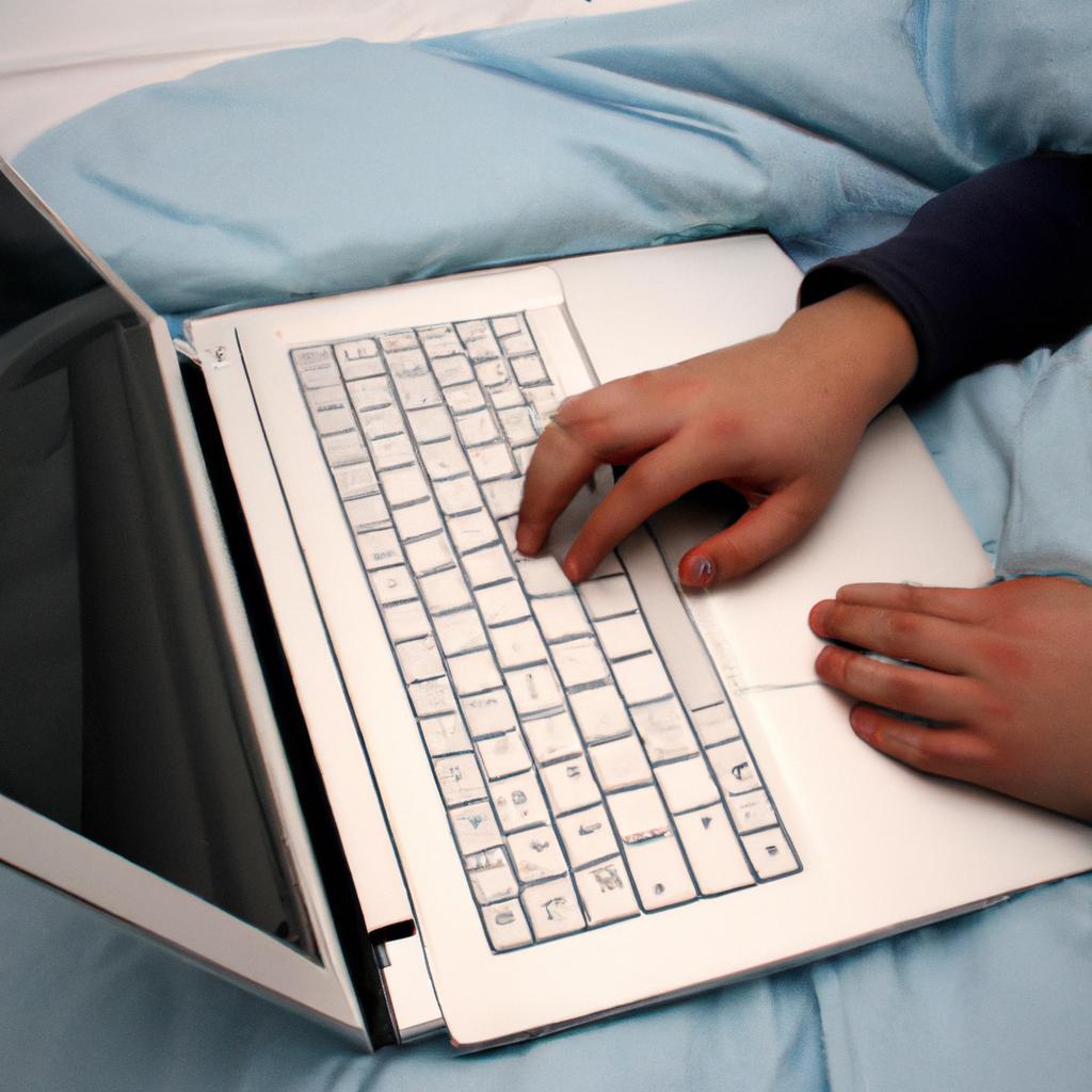 Person using laptop in bed
